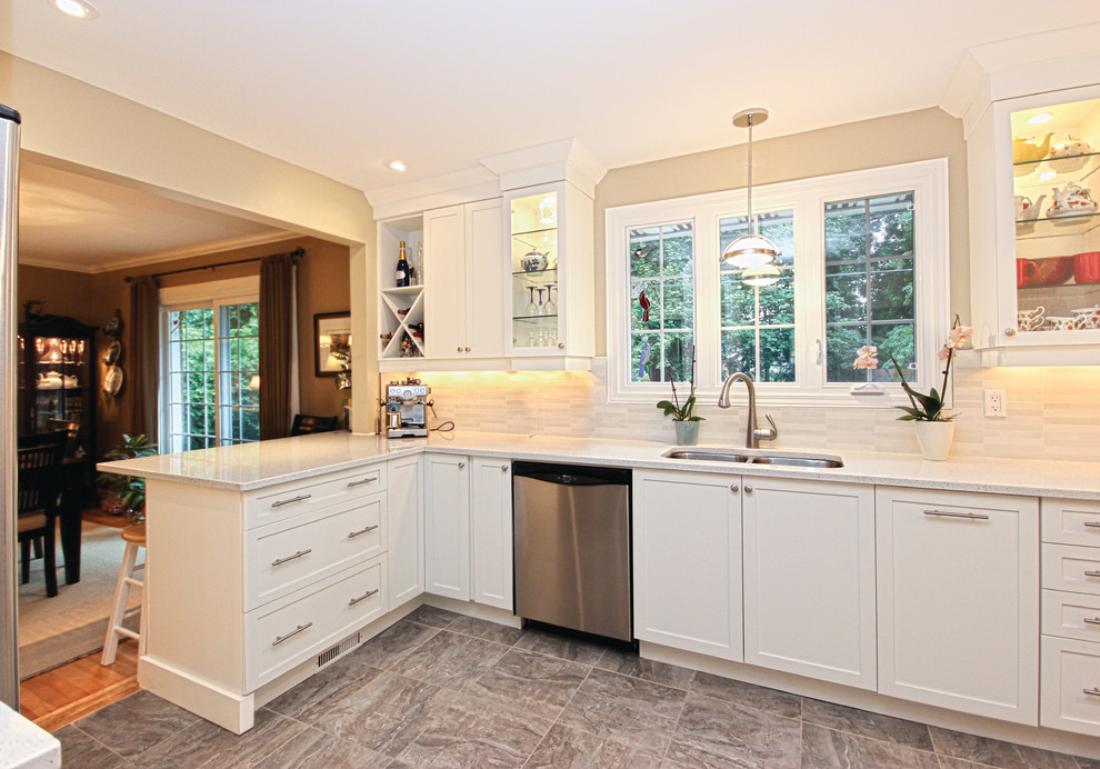This is an example of a medium sized classic l-shaped enclosed kitchen in Ottawa with a double-bowl sink, recessed-panel cabinets, white cabinets, granite worktops, white splashback, stone tiled splashback, stainless steel appliances and a breakfast bar.