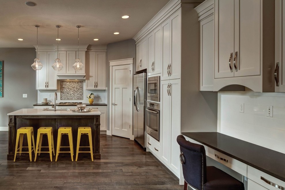 Example of a small transitional l-shaped dark wood floor and brown floor open concept kitchen design in Minneapolis with an undermount sink, shaker cabinets, white cabinets, quartzite countertops, multicolored backsplash, mosaic tile backsplash, stainless steel appliances and an island