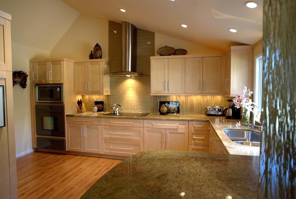 Example of a mid-sized trendy l-shaped bamboo floor and brown floor enclosed kitchen design in San Diego with an undermount sink, flat-panel cabinets, light wood cabinets, granite countertops, green backsplash, glass tile backsplash, black appliances and no island