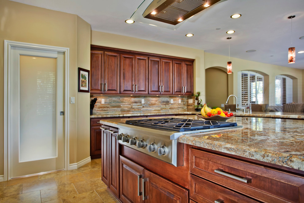Example of a classic u-shaped eat-in kitchen design in San Diego with a double-bowl sink, raised-panel cabinets, dark wood cabinets, granite countertops, multicolored backsplash and stainless steel appliances