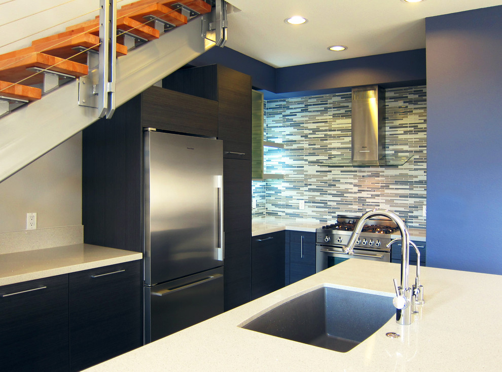 Eat-in kitchen - small modern l-shaped ceramic tile eat-in kitchen idea in Los Angeles with an undermount sink, flat-panel cabinets, black cabinets, quartz countertops, multicolored backsplash and stainless steel appliances