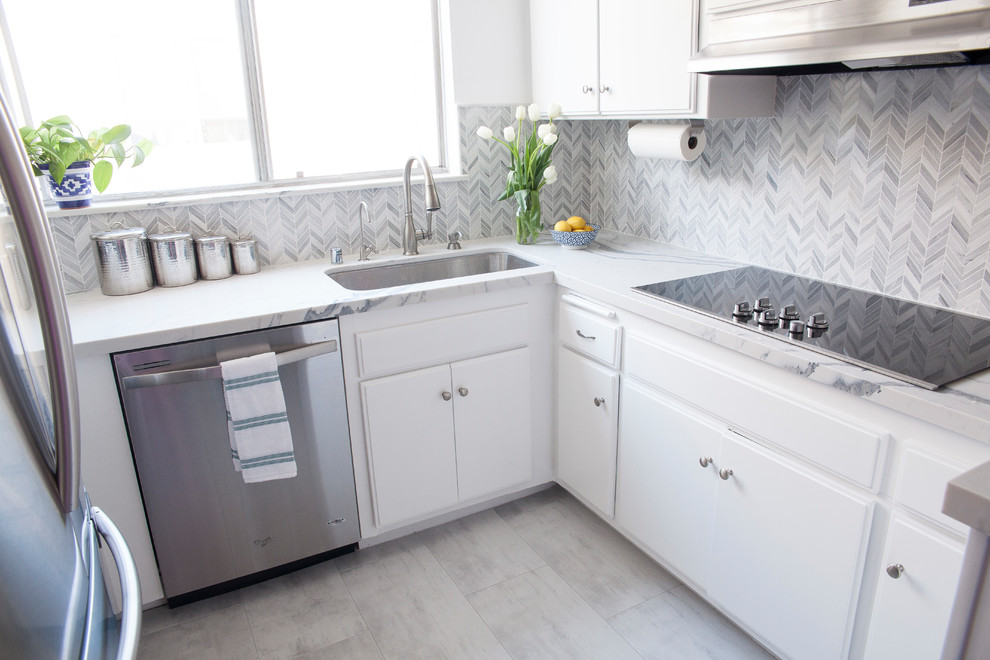 Inspiration for a small contemporary u-shaped porcelain tile and gray floor eat-in kitchen remodel in Los Angeles with an undermount sink, flat-panel cabinets, white cabinets, quartz countertops, gray backsplash, porcelain backsplash, stainless steel appliances and no island