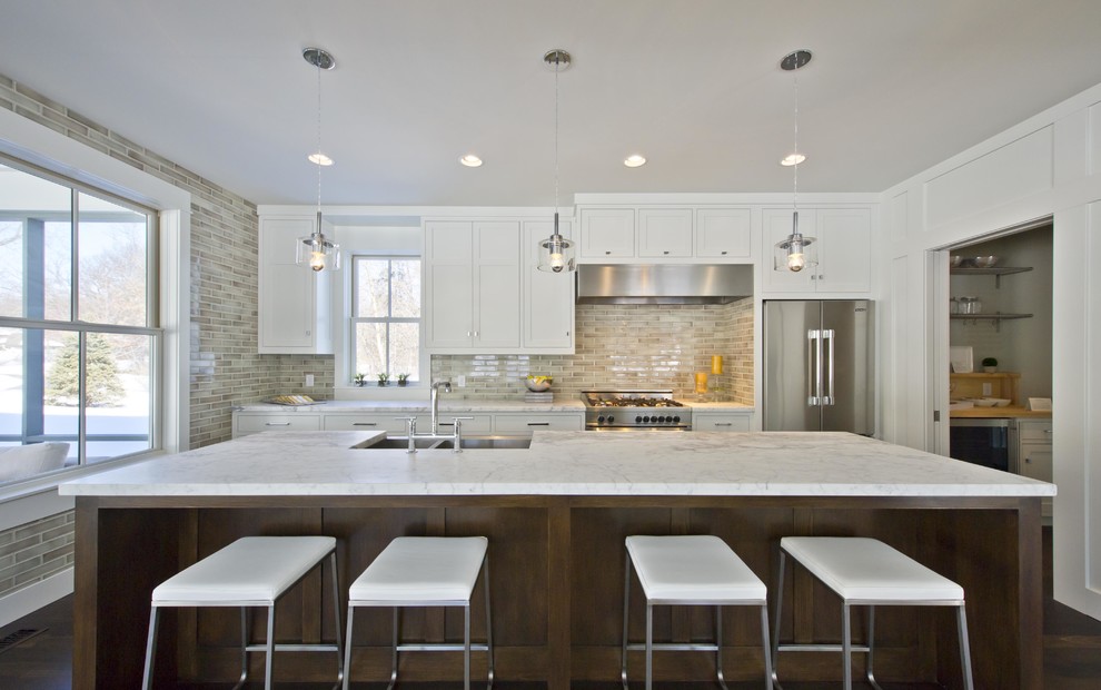 Example of a large trendy galley porcelain tile and brown floor eat-in kitchen design in San Francisco with marble countertops, gray backsplash, ceramic backsplash, stainless steel appliances, an island, a farmhouse sink, shaker cabinets and white cabinets