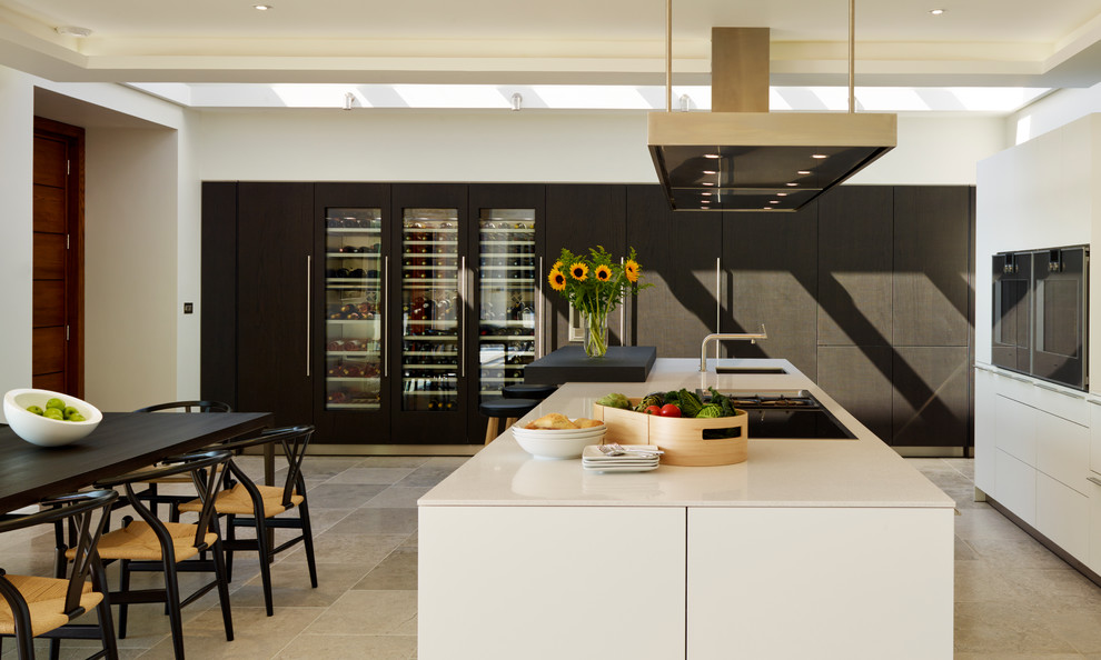 Large nautical galley kitchen/diner in Devon with an integrated sink, flat-panel cabinets, white cabinets, quartz worktops, integrated appliances and an island.