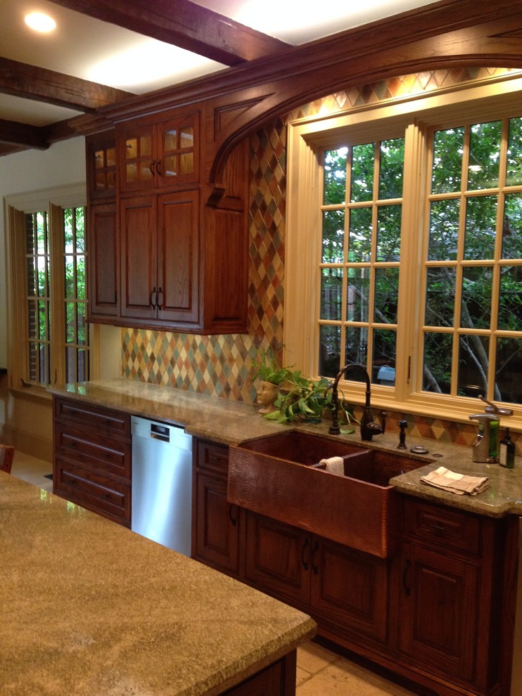 Exempel på ett stort klassiskt kök, med en rustik diskho, luckor med upphöjd panel, skåp i mellenmörkt trä, granitbänkskiva, flerfärgad stänkskydd, stänkskydd i cementkakel, rostfria vitvaror, travertin golv och en köksö
