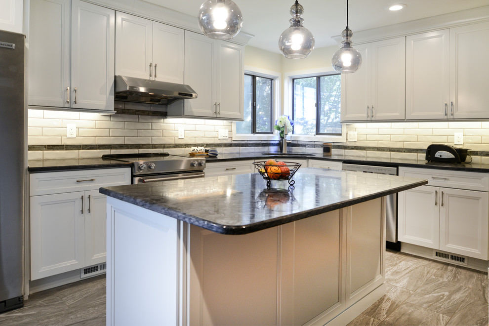 Exempel på ett mellanstort modernt grå grått kök och matrum, med släta luckor, vita skåp, granitbänkskiva, vitt stänkskydd, rostfria vitvaror, en köksö och grått golv