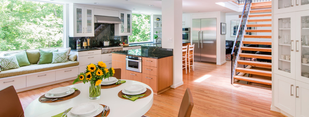 Example of a large transitional l-shaped light wood floor eat-in kitchen design in DC Metro with flat-panel cabinets, light wood cabinets, quartzite countertops, stainless steel appliances and an island