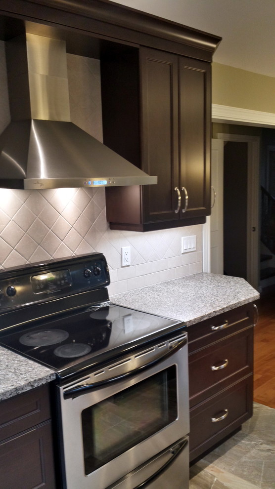 Example of a small classic l-shaped porcelain tile eat-in kitchen design in Ottawa with a double-bowl sink, recessed-panel cabinets, dark wood cabinets, granite countertops, gray backsplash, ceramic backsplash, stainless steel appliances and a peninsula