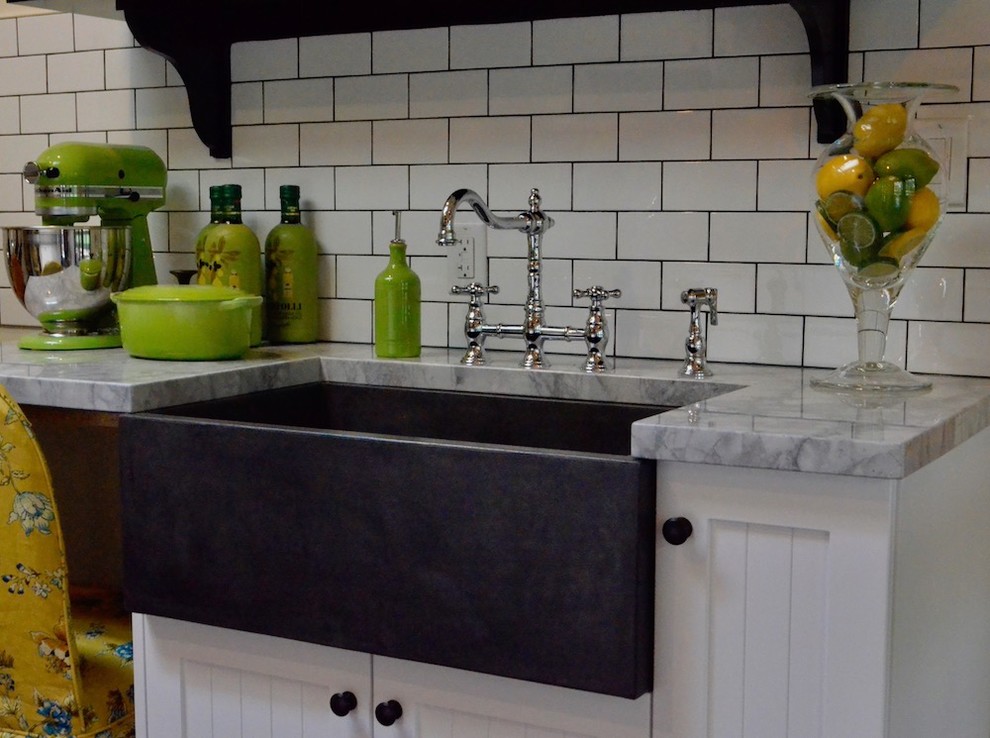 Rural kitchen in Toronto with a belfast sink, beaded cabinets, white cabinets, marble worktops, white splashback, metro tiled splashback and grey worktops.
