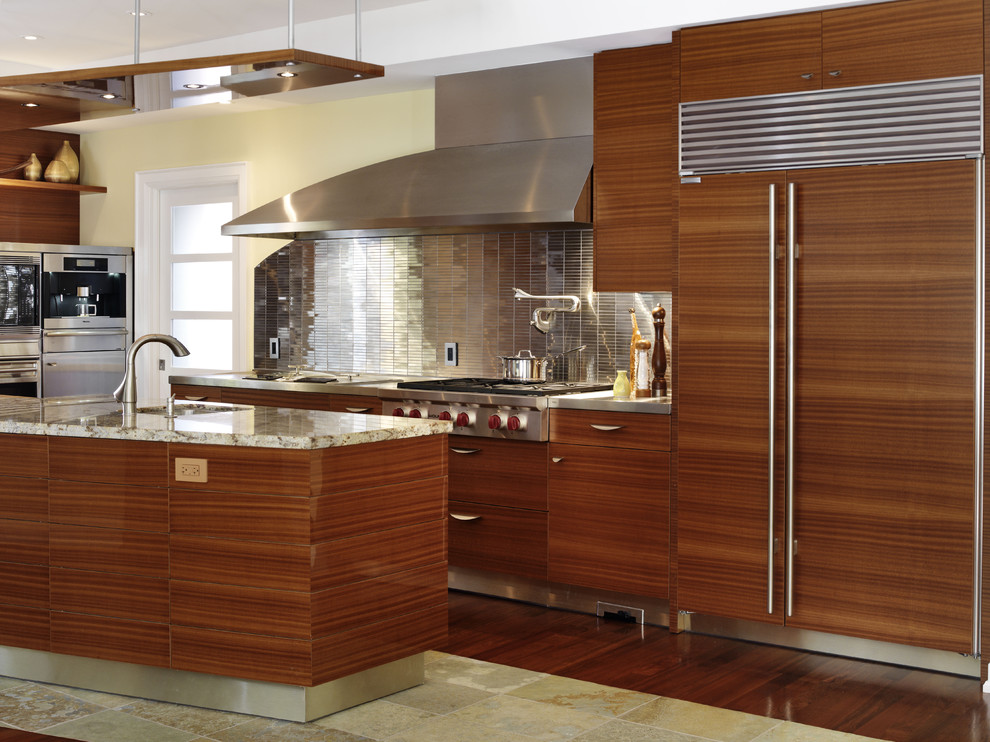 Design ideas for a world-inspired l-shaped kitchen in Toronto with a submerged sink, flat-panel cabinets, medium wood cabinets, metallic splashback, metal splashback, integrated appliances, slate flooring and an island.