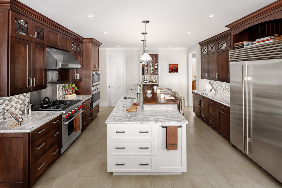 Large elegant beige floor enclosed kitchen photo in Other with shaker cabinets, dark wood cabinets, an island, an undermount sink, multicolored backsplash, mosaic tile backsplash and stainless steel appliances