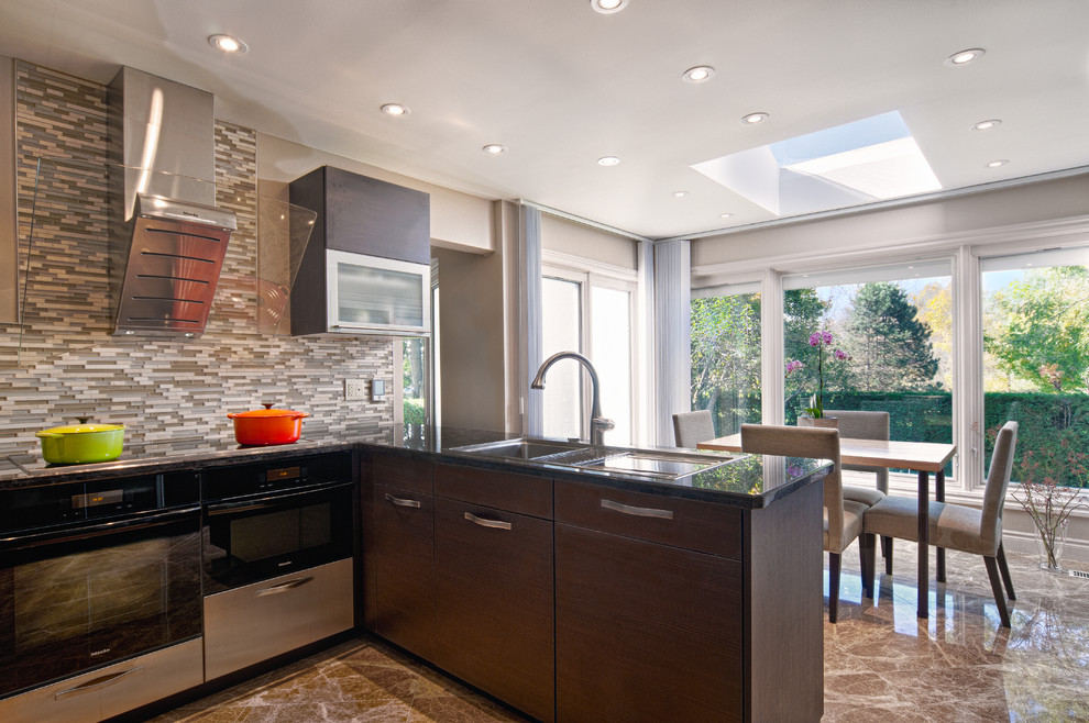 Eat-in kitchen - large contemporary l-shaped marble floor and beige floor eat-in kitchen idea in Toronto with a drop-in sink, flat-panel cabinets, dark wood cabinets, marble countertops, gray backsplash, glass tile backsplash, stainless steel appliances and a peninsula