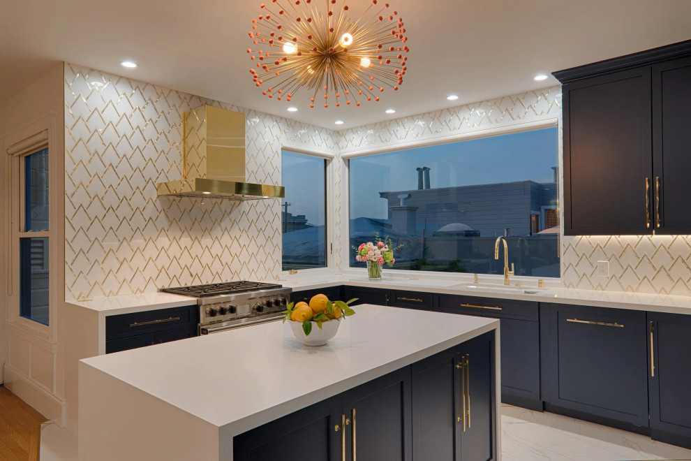 Mid-sized transitional u-shaped porcelain tile and white floor kitchen photo in San Francisco with an undermount sink, shaker cabinets, blue cabinets, quartz countertops, metallic backsplash, marble backsplash, stainless steel appliances, an island and white countertops
