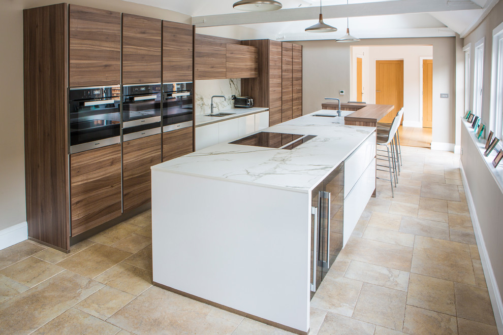 Design ideas for a large contemporary single-wall open plan kitchen in Essex with an integrated sink, flat-panel cabinets, medium wood cabinets, quartz worktops, white splashback, stone slab splashback, integrated appliances and an island.