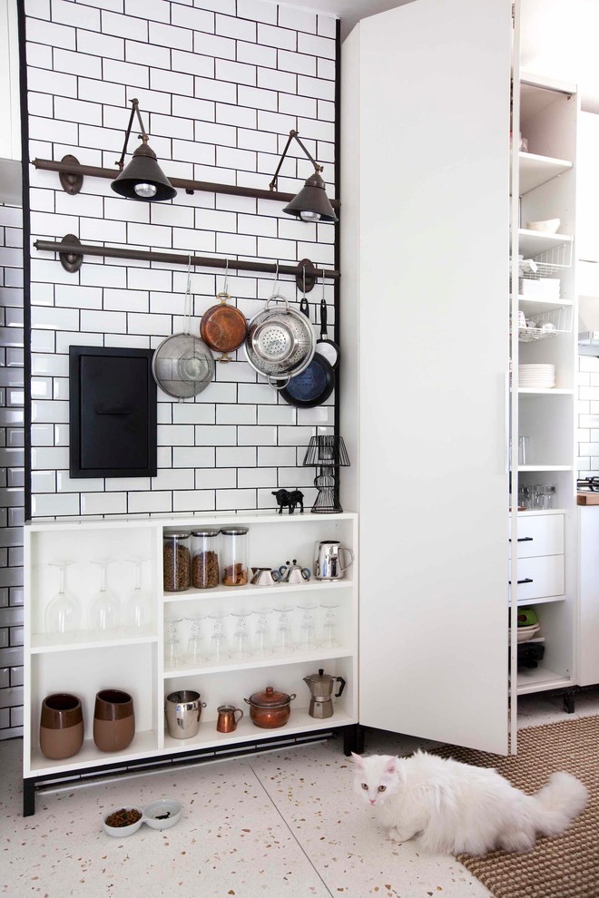 Inspiration for a contemporary kitchen in Other with white cabinets, white splashback and metro tiled splashback.
