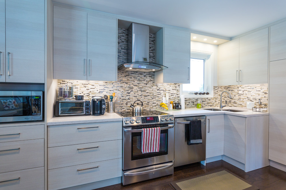 Mid-sized trendy l-shaped vinyl floor and brown floor eat-in kitchen photo in Toronto with a double-bowl sink, flat-panel cabinets, light wood cabinets, multicolored backsplash, matchstick tile backsplash, stainless steel appliances and an island