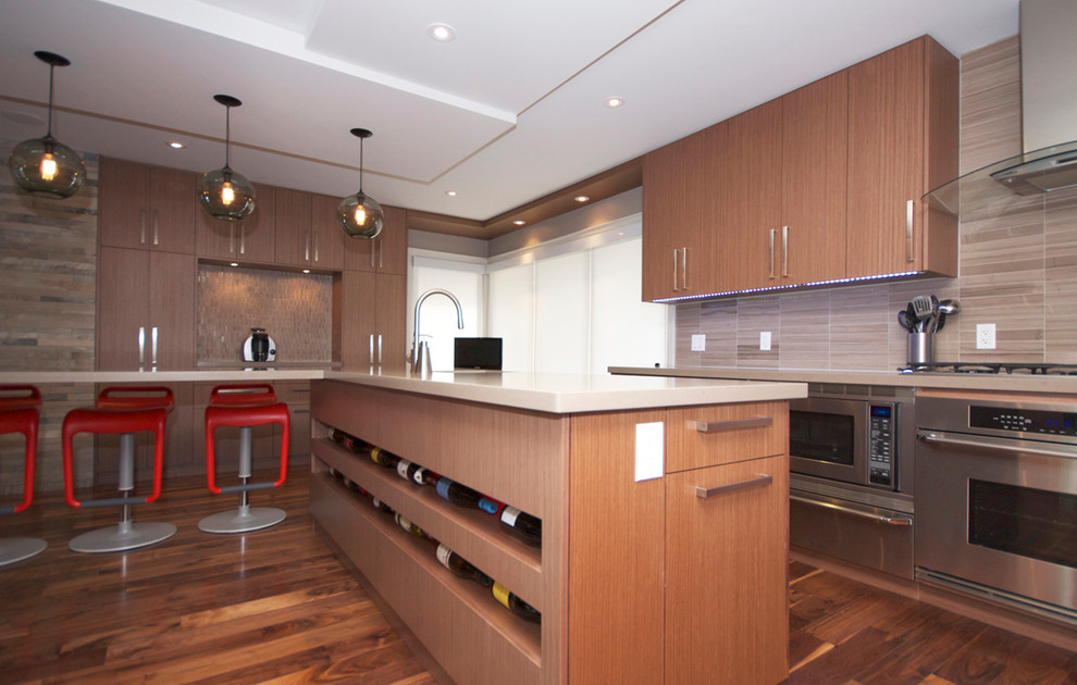 トロントにあるコンテンポラリースタイルのおしゃれなキッチン (フラットパネル扉のキャビネット、淡色木目調キャビネット、ベージュキッチンパネル、シルバーの調理設備) の写真