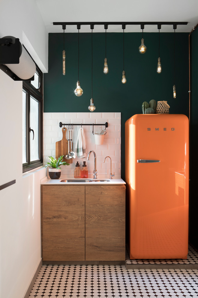 Photo of a scandi kitchen in Singapore with a submerged sink, flat-panel cabinets, light wood cabinets, white splashback, metro tiled splashback, coloured appliances, multi-coloured floors and white worktops.