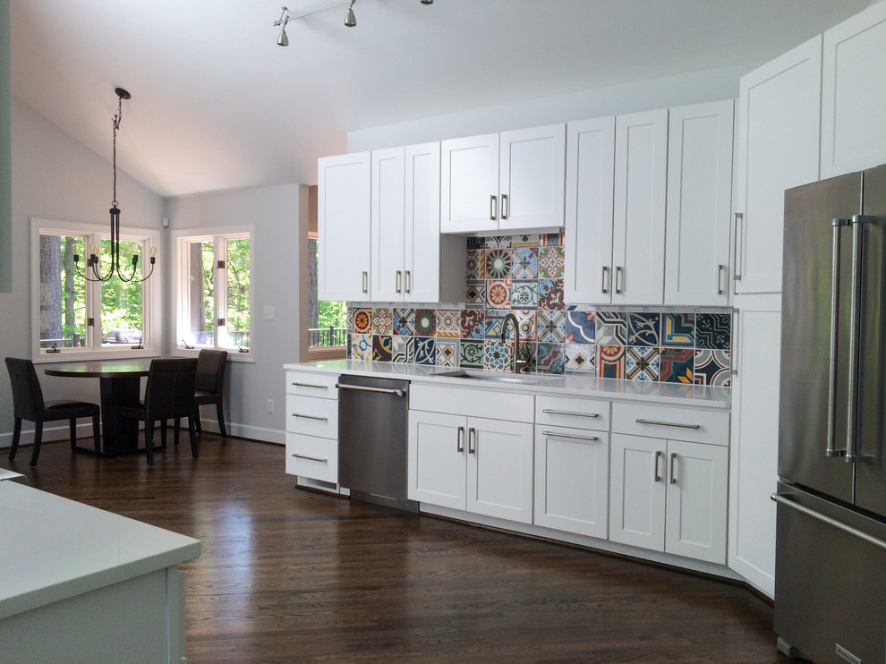 Medium sized modern galley kitchen in Raleigh with a submerged sink, flat-panel cabinets, white cabinets, engineered stone countertops, multi-coloured splashback, porcelain splashback, stainless steel appliances, dark hardwood flooring and no island.