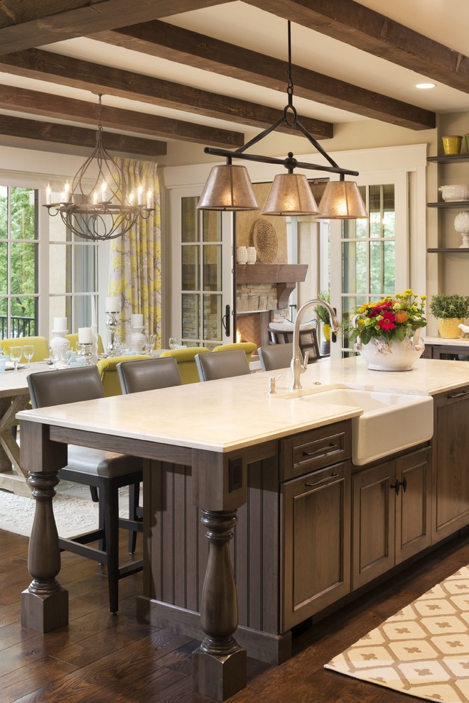 Design ideas for a medium sized classic single-wall kitchen/diner in Minneapolis with a belfast sink, flat-panel cabinets, medium wood cabinets, limestone worktops, stainless steel appliances, medium hardwood flooring and an island.