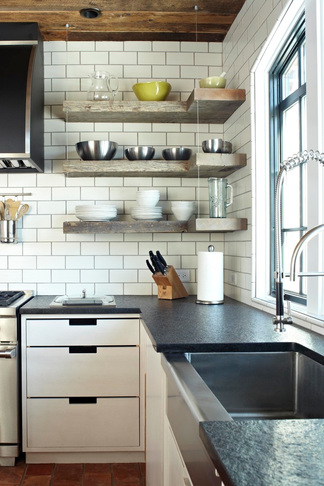Example of a transitional kitchen design in Chicago with an undermount sink, flat-panel cabinets, white cabinets, white backsplash, subway tile backsplash and stainless steel appliances