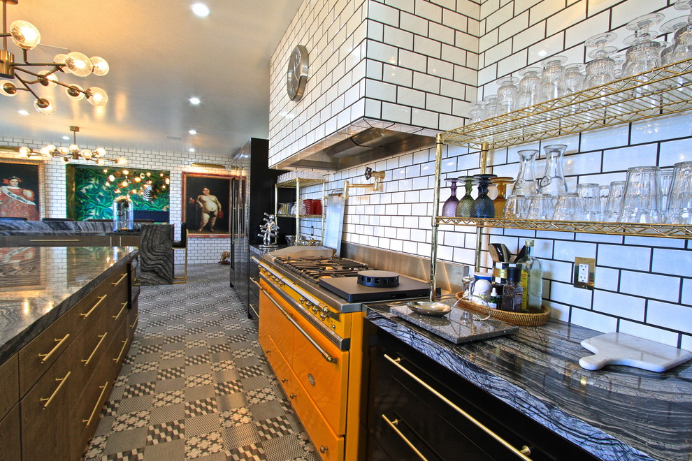 Enclosed kitchen - huge eclectic l-shaped ceramic tile enclosed kitchen idea in Orange County with an undermount sink, flat-panel cabinets, gray cabinets, marble countertops, white backsplash, subway tile backsplash, black appliances and an island