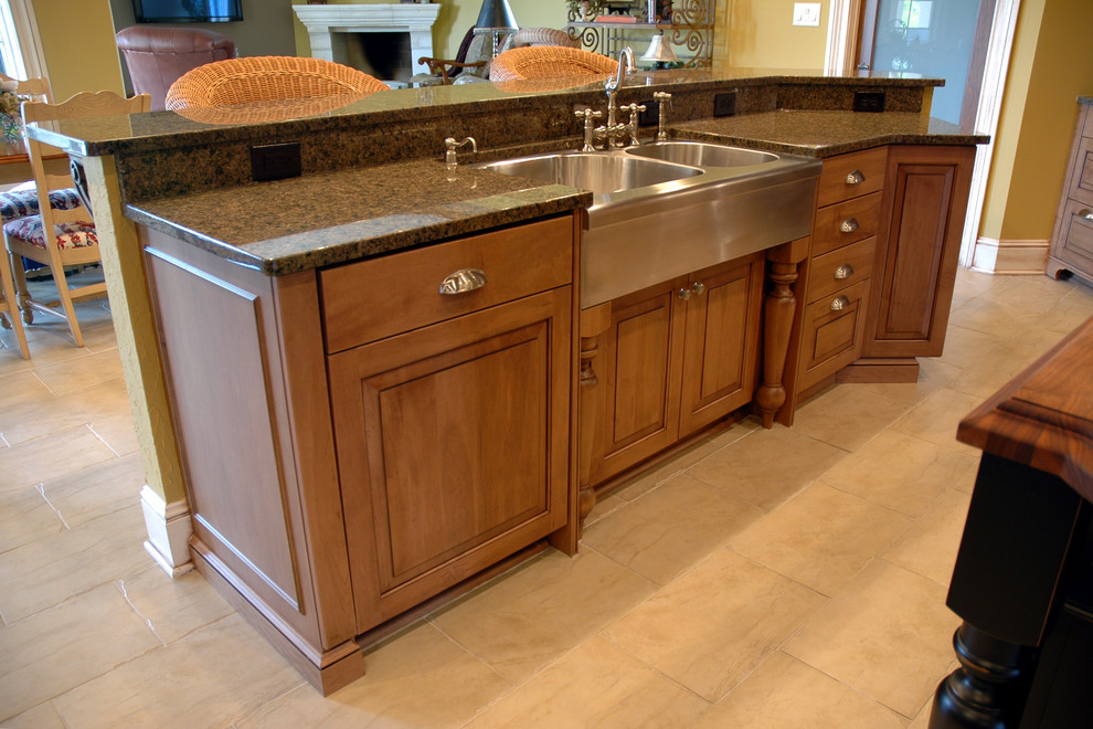 Photo of a classic u-shaped kitchen/diner in Indianapolis with a belfast sink, raised-panel cabinets, medium wood cabinets, wood worktops and integrated appliances.