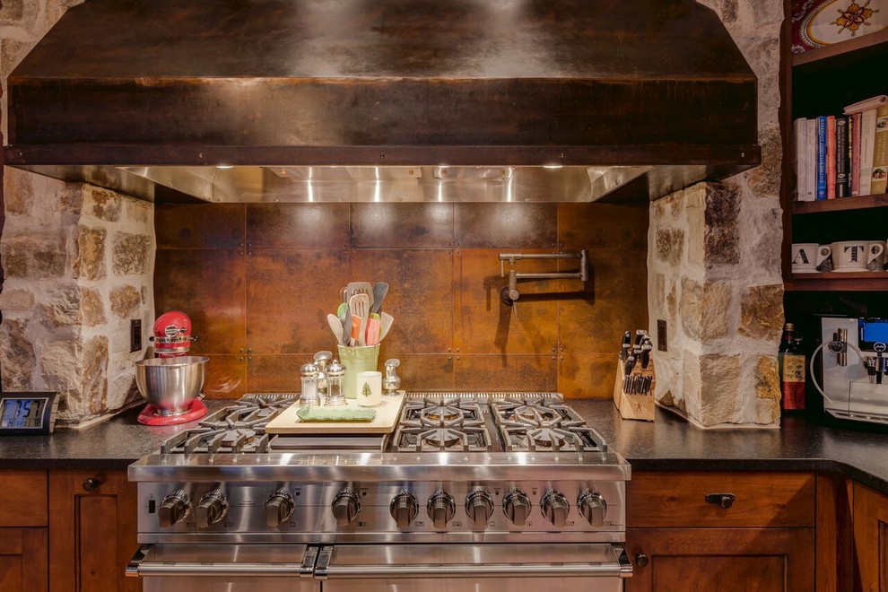 Photo of a large rustic kitchen in Denver with light hardwood flooring.