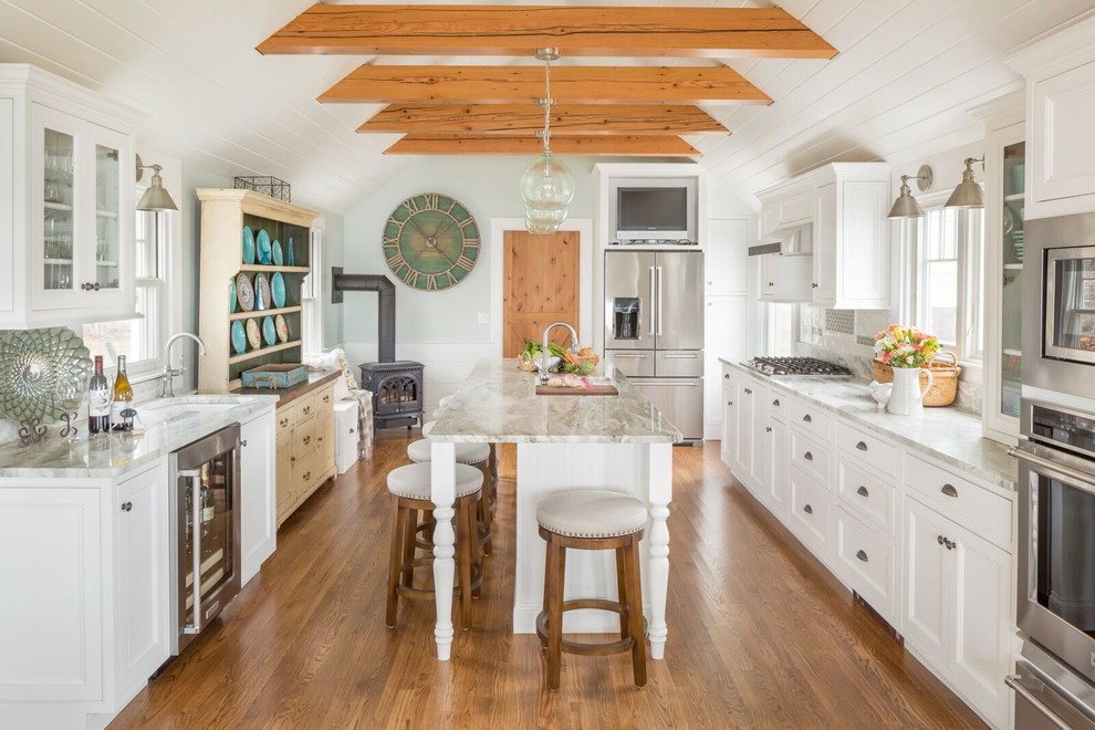 Inspiration for a country kitchen in Bridgeport with a submerged sink, recessed-panel cabinets, white cabinets, white splashback, dark hardwood flooring and an island.