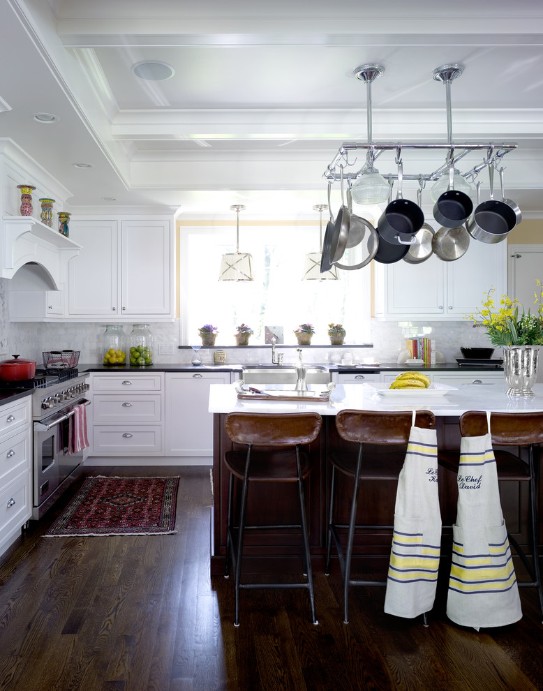 Inspiration for a classic kitchen in Chicago with white cabinets, white splashback and stainless steel appliances.