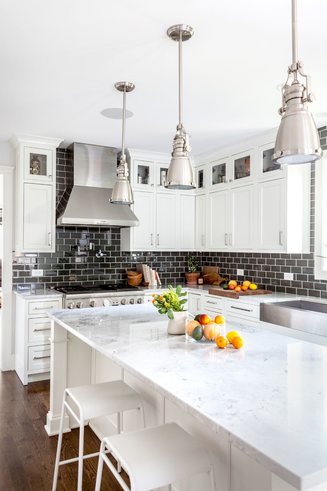 Kitchen - eclectic dark wood floor and brown floor kitchen idea in Chicago with an undermount sink, shaker cabinets, white cabinets, granite countertops, black backsplash, ceramic backsplash, stainless steel appliances, an island and white countertops