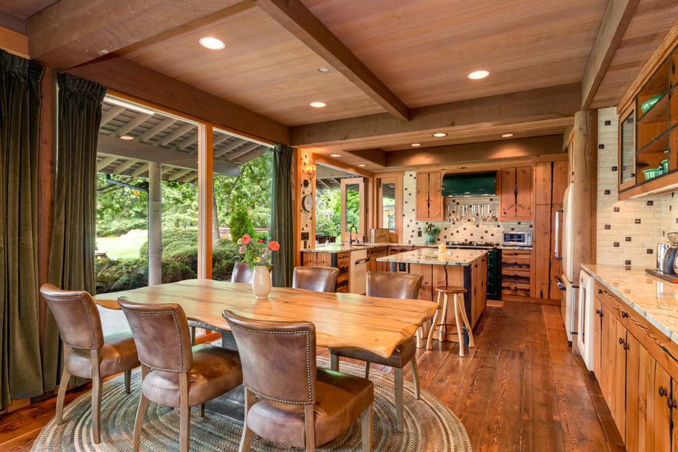 Example of a large cottage medium tone wood floor eat-in kitchen design in Seattle with medium tone wood cabinets, granite countertops, multicolored backsplash, porcelain backsplash, white appliances and an island