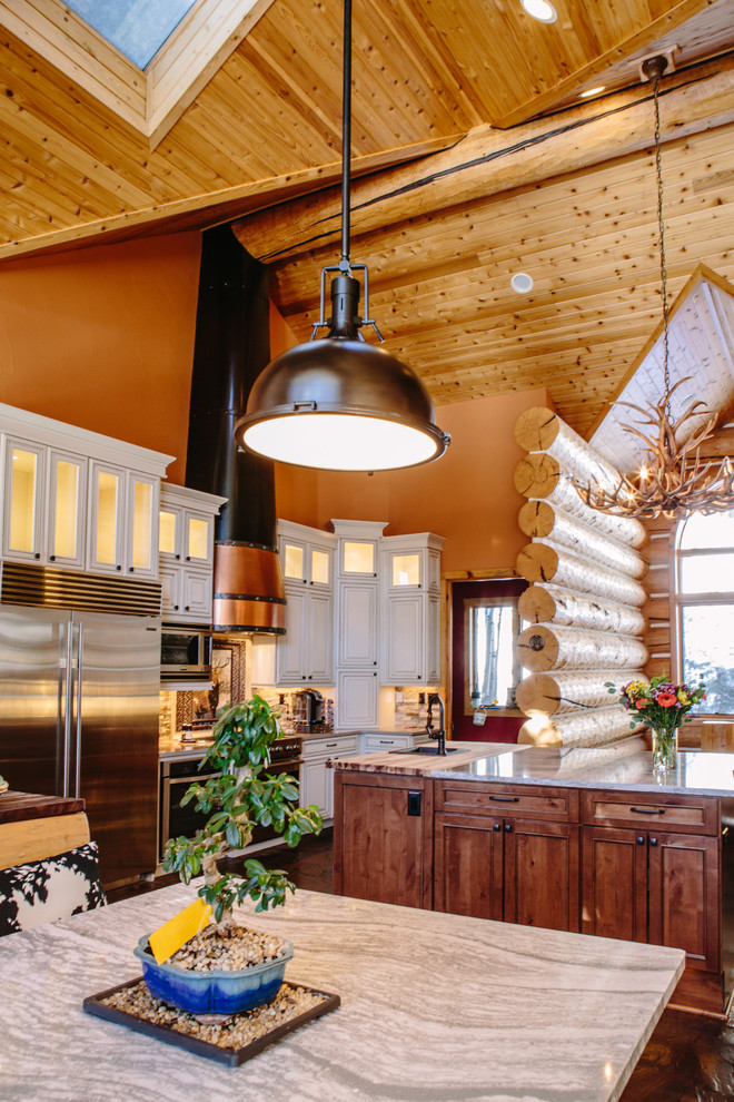 Example of a huge mountain style u-shaped slate floor eat-in kitchen design in Denver with an undermount sink, raised-panel cabinets, beige cabinets, quartz countertops, multicolored backsplash, stone tile backsplash, stainless steel appliances and an island