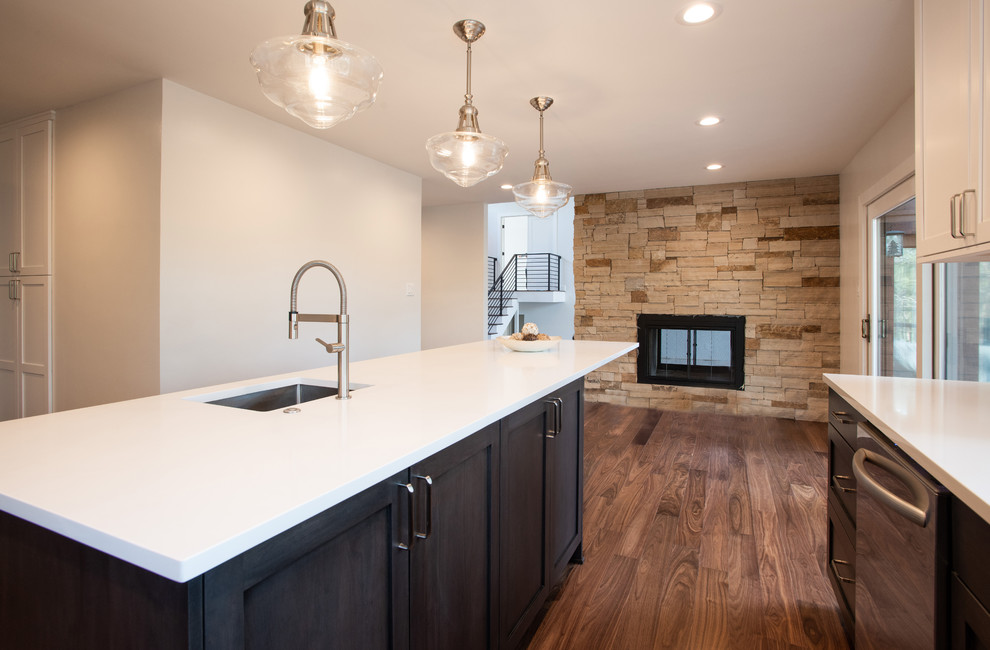Photo of a medium sized contemporary l-shaped enclosed kitchen in Denver with a submerged sink, shaker cabinets, white cabinets, engineered stone countertops, multi-coloured splashback, marble splashback, stainless steel appliances, medium hardwood flooring, an island and white worktops.