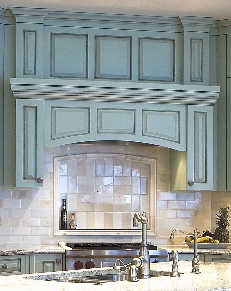 Example of a classic l-shaped eat-in kitchen design in Minneapolis with an undermount sink, raised-panel cabinets, blue cabinets, granite countertops, white backsplash, stone tile backsplash and paneled appliances