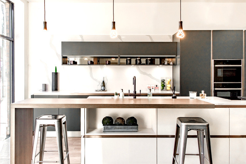 Mid-sized minimalist eat-in kitchen photo in London with an island