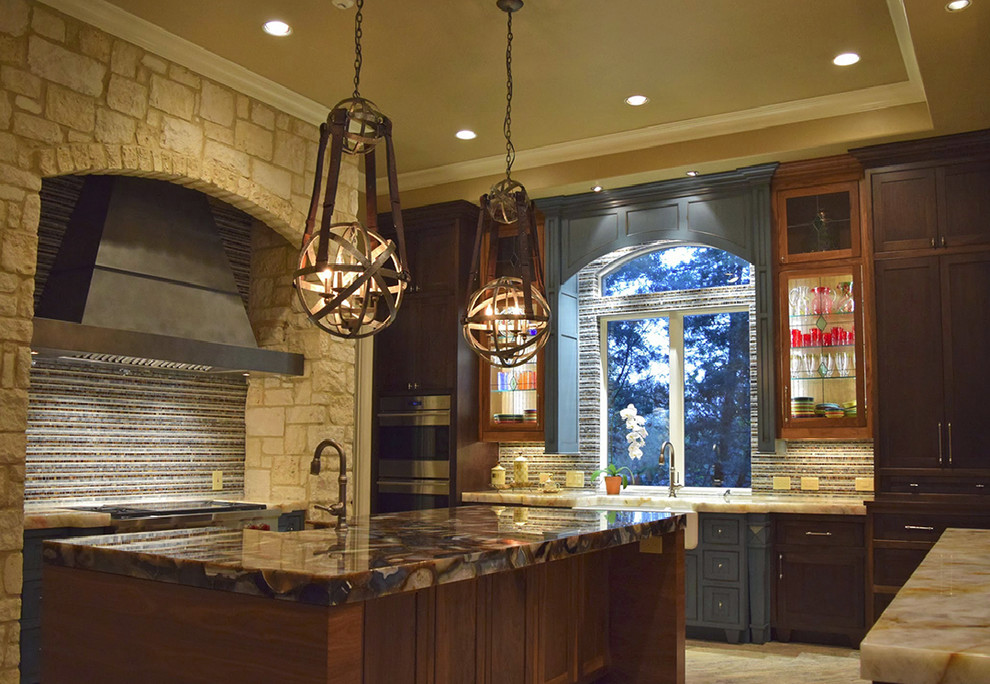 Contemporary kitchen in Austin with a belfast sink, engineered stone countertops and an island.