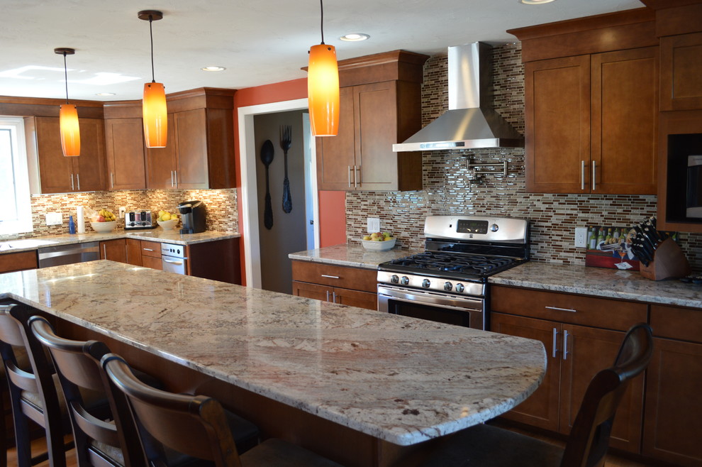 Transitional l-shaped eat-in kitchen photo in Boston with a single-bowl sink, shaker cabinets, medium tone wood cabinets, granite countertops, brown backsplash, glass tile backsplash and stainless steel appliances