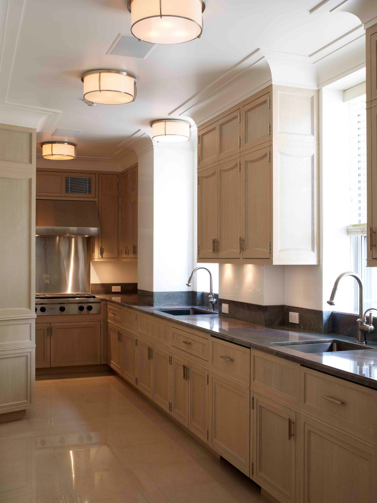 This is an example of a traditional l-shaped kitchen in New York with a submerged sink, beaded cabinets, light wood cabinets, marble worktops, brown splashback, stone slab splashback, stainless steel appliances, ceramic flooring, beige floors and brown worktops.