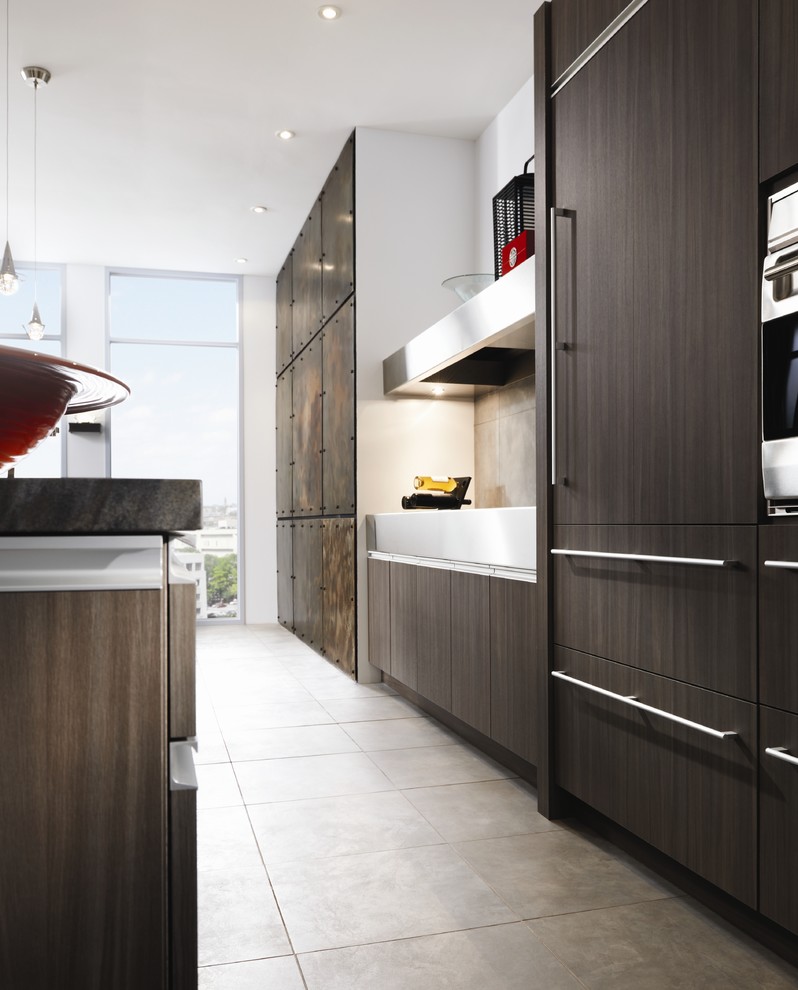 Inspiration for a contemporary kitchen in St Louis with dark wood cabinets and integrated appliances.