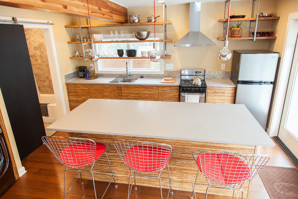 Open concept kitchen - small contemporary single-wall bamboo floor open concept kitchen idea in Portland with an undermount sink, flat-panel cabinets, medium tone wood cabinets, quartzite countertops, metallic backsplash, metal backsplash, stainless steel appliances and an island