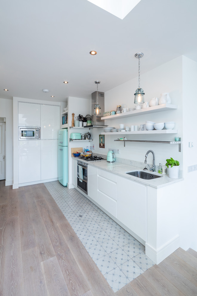 Offene, Kleine Moderne Küche ohne Insel mit Küchenrückwand in Weiß, bunten Elektrogeräten und weißer Arbeitsplatte in Sonstige