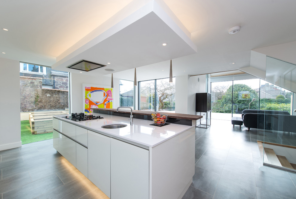 Mittelgroße Moderne Wohnküche mit weißen Schränken und Kücheninsel in Sonstige