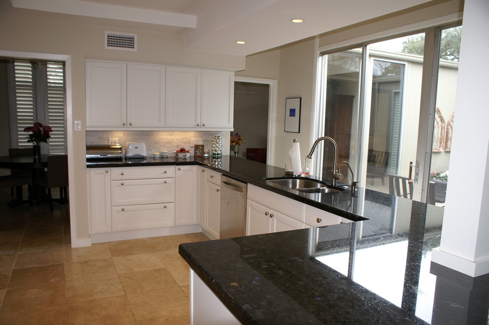 Medium sized contemporary kitchen in Houston with white cabinets, grey splashback, stone tiled splashback, stainless steel appliances and ceramic flooring.