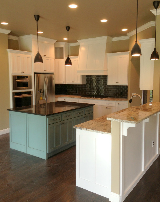 Inspiration for a large kitchen remodel in Oklahoma City with white cabinets, stainless steel appliances and an island