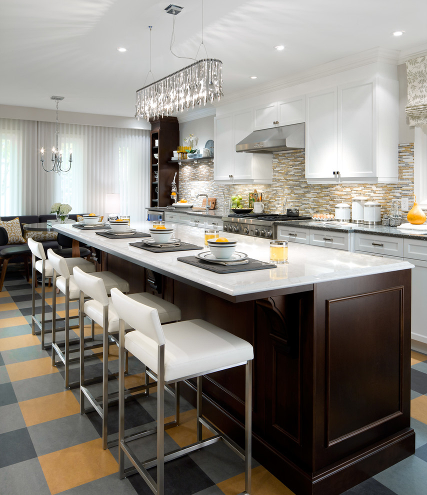 Inspiration for a transitional galley eat-in kitchen remodel in Toronto with recessed-panel cabinets, white cabinets, metallic backsplash, mosaic tile backsplash, stainless steel appliances and an island