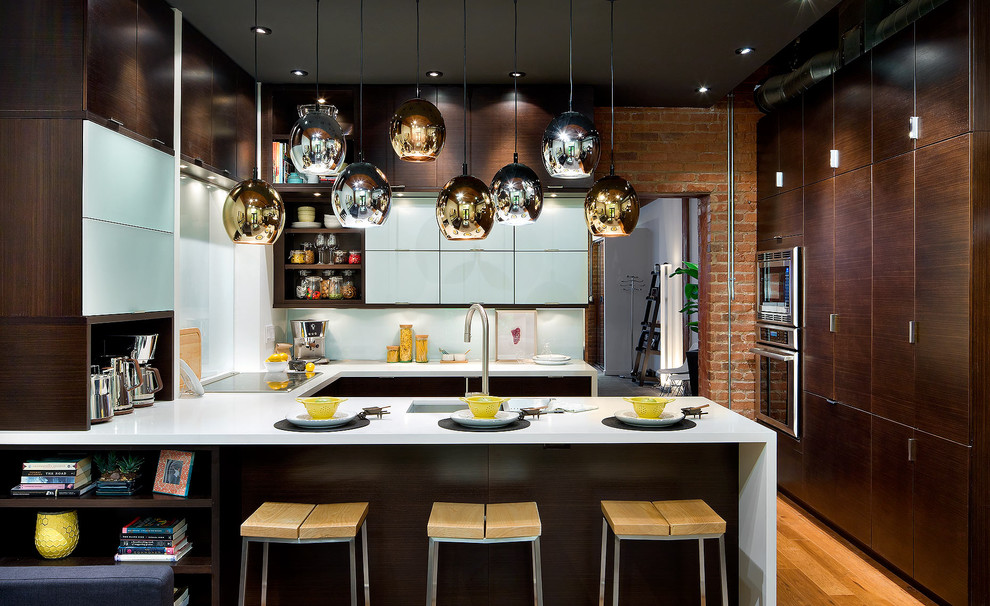 Photo of a contemporary u-shaped kitchen in Toronto with a submerged sink, flat-panel cabinets, dark wood cabinets, white splashback, stainless steel appliances, medium hardwood flooring and a breakfast bar.