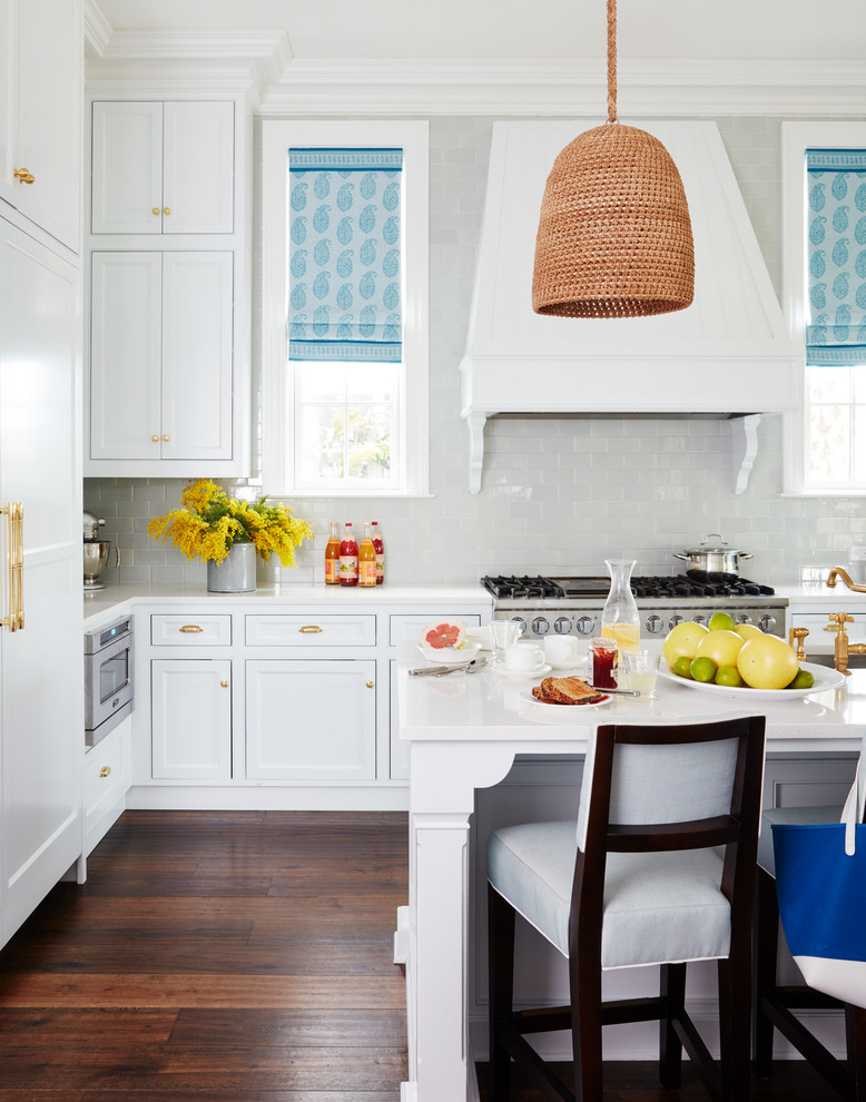 Example of a large transitional l-shaped dark wood floor and brown floor open concept kitchen design in Jacksonville with beaded inset cabinets, white cabinets, soapstone countertops, gray backsplash, stone tile backsplash, stainless steel appliances, an island and an undermount sink