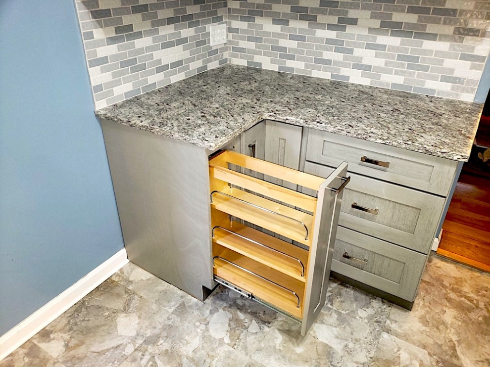 Inspiration for a small modern galley vinyl floor and beige floor enclosed kitchen remodel in DC Metro with an undermount sink, shaker cabinets, gray cabinets, granite countertops, gray backsplash, mosaic tile backsplash, stainless steel appliances and gray countertops