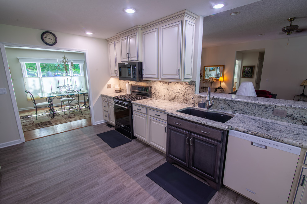Kitchen - large traditional vinyl floor kitchen idea in Other with an undermount sink, raised-panel cabinets, granite countertops, multicolored backsplash and multicolored countertops